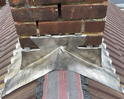 Professional roofing team installing lead flashing